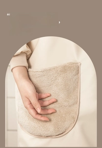 Close-up of beige kitchen apron with absorbent coral fleece hand-wiping pocket feature