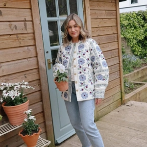 Floral quilted cotton jacket with blue and purple flowers on a white background