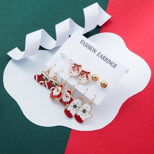 Close-up of a 6-piece Christmas earring set featuring Santa Claus and tree designs