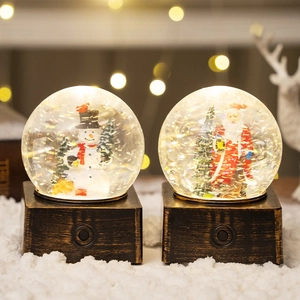 Luminous Christmas snow globe set with Santa and Snowman on antique bronze bases