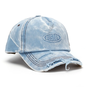 Close-up of Boston embroidery and distressed details on light blue denim baseball cap