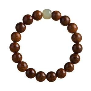 Natural Golden Phoebe wood Buddhist prayer beads with a green jade accent on white background