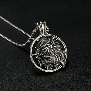 Detailed view of silver Jesus crown of thorns pendant on a polished metal chain