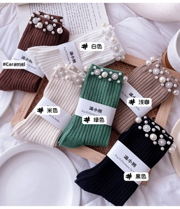 Detail of ribbed knit socks with hand-stitched pearls and crystal flower accents