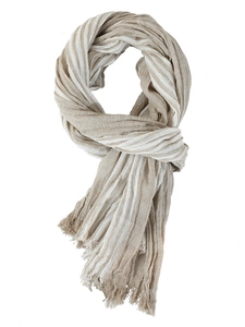 Detail of beige and white striped scarf featuring crinkle texture and tassel edges