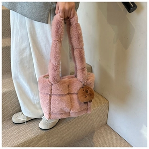 Detailed texture of pink quilted plush tote bag featuring a cute brown bear charm