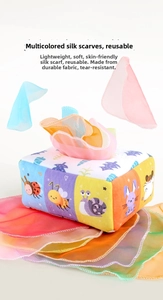 Detail of infant sensory tissue box toy with colorful scarves and cartoon animal prints