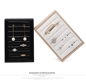 Detail view of leather texture jewelry display trays for rings and earrings in two colors