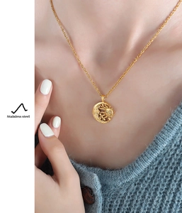 Macro detail of retro sun and moon pendant necklace made of high-quality stainless steel