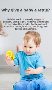 Detail view of baby playing with lemon-shaped wooden castanet for sensory development