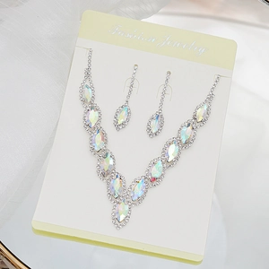 Macro detail of silver bridal jewelry set with marquise iridescent crystal rhinestones