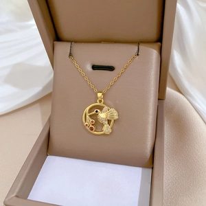 Elegant gold hummingbird pendant necklace with sparkling crystals in a luxury gift box