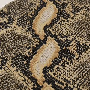 Detailed macro view of the realistic snake skin pattern on the leather military hat crown
