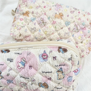 Macro shot of quilted texture and cute cartoon puppy pattern on large makeup pouch