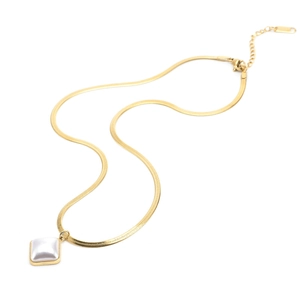 Detailed view of golden snake chain necklace with a square white pearl pendant