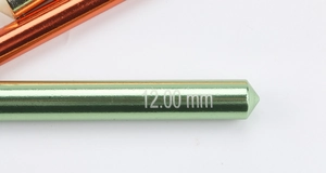 Macro shot of 12mm green alumina crochet hook tip with size engraving detail