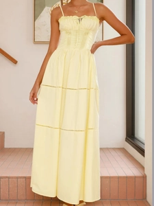 Close-up of pale yellow camisole dress featuring pleated bust and delicate lace splicing