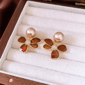 Elegant gold-plated flower earrings with brown enamel petals, champagne pearls, and zircons