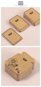 Macro detail of kraft paper earring cards with crown logo for jewelry packaging displays