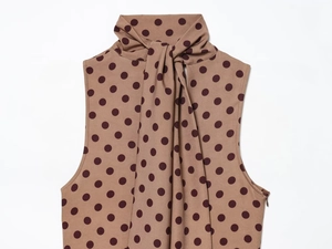 Detailed view of coffee brown polka dot sleeveless top with bow tie neckline