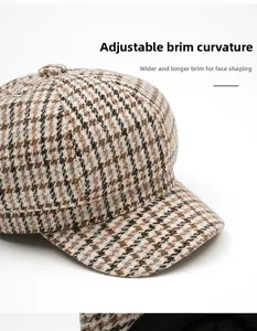Detail of classic houndstooth newsboy cap featuring a flexible foldable brim design
