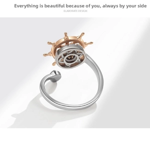 Detail of nautical rudder ring in two-tone silver and rose gold with adjustable band