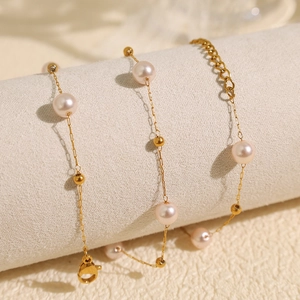 Minimalist gold beaded pearl necklace with adjustable lobster clasp on white display