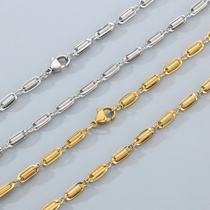 Detail of silver and gold link chains featuring intricate spiral textures and spring clasps