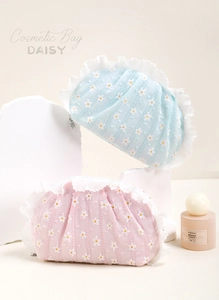 Detailed close-up of daisy print cosmetic bags with elegant lace trim and 3D floral texture