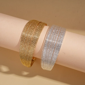 Multilayer geometric open cuff bracelets in gold and silver finish with sparkling texture