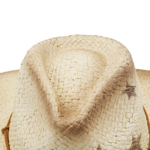 Macro shot of rustic straw cowboy hat crown with vintage star print and weave detail