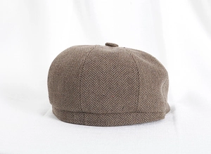 Dettaglio macro del tessuto a spina di pesce marrone e cuciture di un cappello retrò