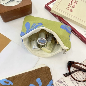 Detailed view of floral canvas makeup bag with zipper showing cosmetic storage space
