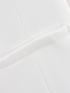 Macro view of high-density twill fabric and premium pocket stitching on white jacket