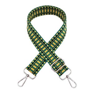 Close-up of green and yellow woven replacement shoulder strap with silver metal buckles