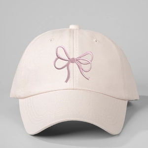 Detailed view of the purple bow embroidery and cotton twill fabric on the pink baseball cap