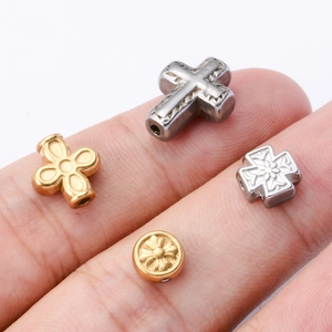 Detailed view of stainless steel cross and flower beads for DIY jewelry making
