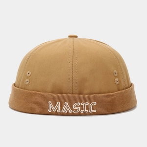 Detailed close-up of khaki docker hat featuring white MASIC embroidery and breathable metal eyelet