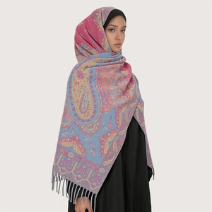 Detail of soft core-spun yarn scarf with paisley pattern and elegant fringe decoration
