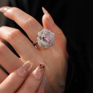 Macro detail of rose flower ring with pink oval stone and pave diamond accents