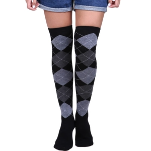 Close-up of classic black and white argyle pattern on elastic over-knee thigh high socks