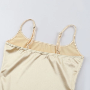 Detail of adjustable straps and glossy satin fabric on the champagne gold midi dress