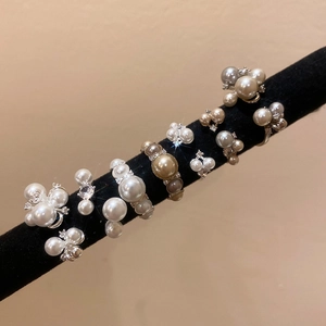 French vintage open rings set with zircon and pearls on a black velvet jewelry display