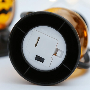 Bottom view of Halloween pumpkin lantern showing battery compartment and LED power switch