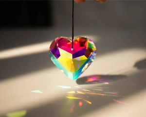 Macro detail of faceted heart crystal suncatcher pendant with rainbow light refraction