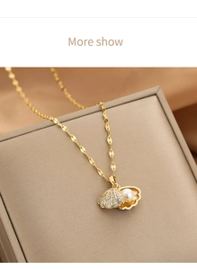 Macro shot of opening gold shell pendant with white pearl and sparkling zircon inlay