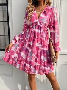 Detail of pink and purple abstract print V-neck dress with ruffle hem and layered skirt