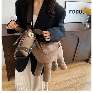 Detail shot of a creative donkey-shaped brown canvas shoulder bag worn by a model