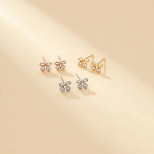 Detailed view of 14K gold plated bow earrings with cherry-shaped zircon stones