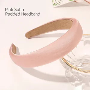Detailed view of pink padded satin headband with non-slip inner lining on a glass bowl